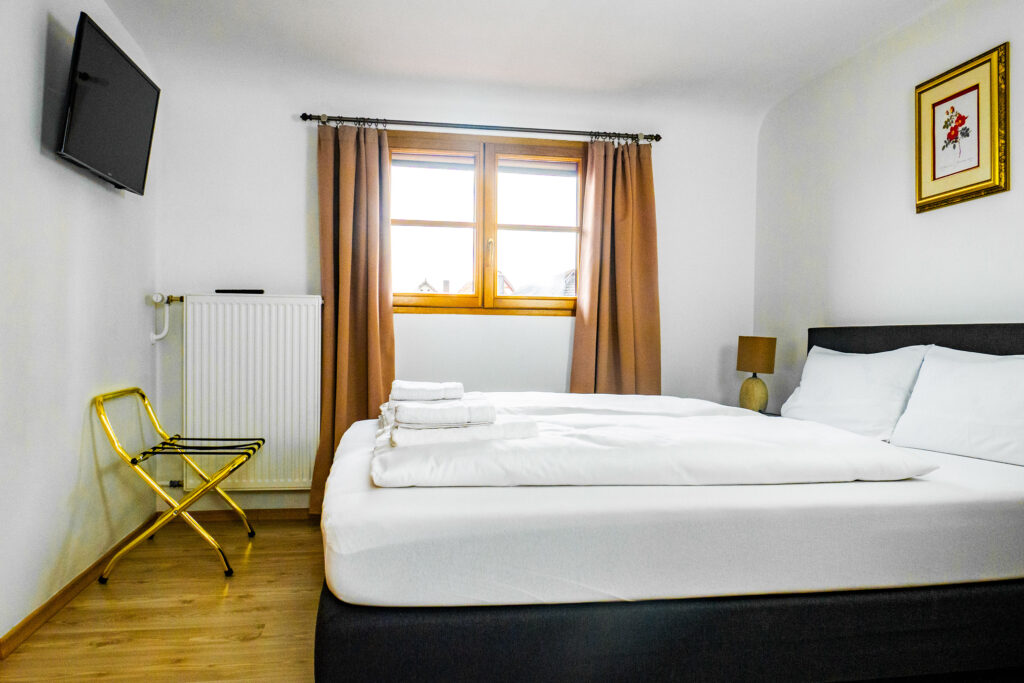 Zimmer 303 – Bett, Fenster und TV